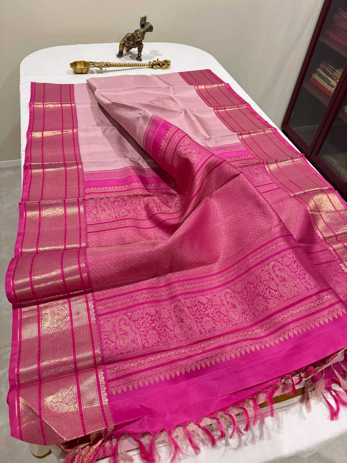 Pink handloom saree displayed elegantly